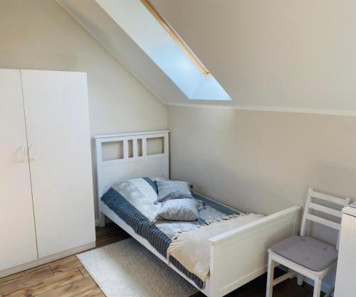 a bedroom with a bed and a skylight at Bursztynowa komnata - apartament in Gdańsk
