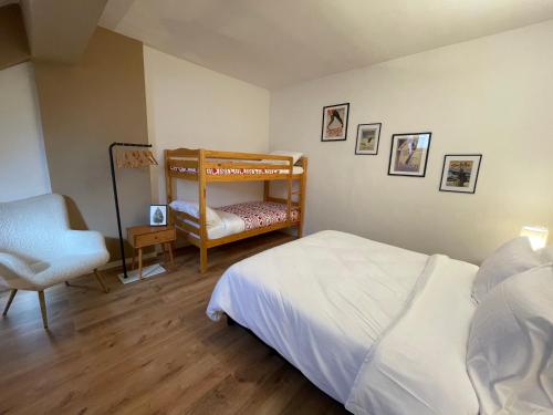 a bedroom with a bunk bed and a chair at Amiata Loft Design - Monte Amiata - Free Parking in Seggiano