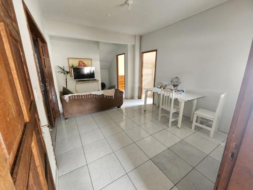 a living room with a couch and a table at Residencial Silveira in Itajaí