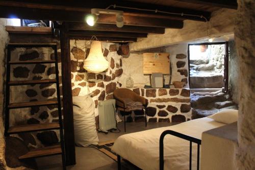 - une chambre avec un mur en pierre dans l'établissement Lugar São Salvador de Monsanto, à Monsanto