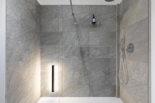 a shower with a glass door in a bathroom at Suite Casa dell'Eden vicino F1/San Gerardo/Monza in Lissone