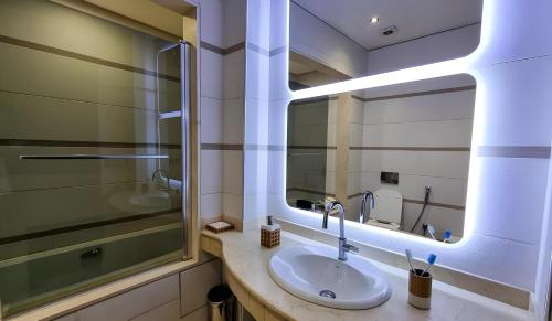 a bathroom with a sink and a mirror at Appartement marina agadir in Agadir