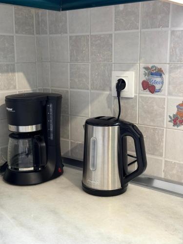 a coffeemaker and coffee pot on a kitchen counter at Aesthetic Cozy Haven in Kremasti