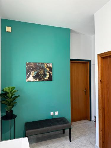a blue wall with a bench in a room at Aesthetic Cozy Haven in Kremasti