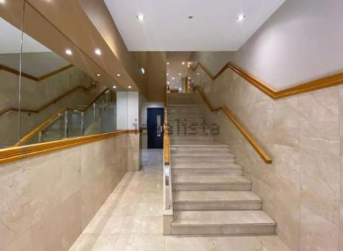 a stairway in a building with stairs and a lobby at CENTRO GIJON CABRALES 31 in Gijón