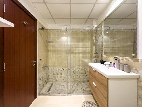 a bathroom with a shower and a sink at JBR Beach, The Walk, 1-BDR with pool view in Dubai