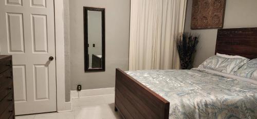 a bedroom with a bed and a mirror and a door at Miami - Brickell - Beaches in Miami