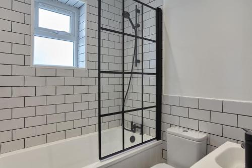 a glass shower in a bathroom with a toilet at Modern house in Carbis Bay in Carbis Bay