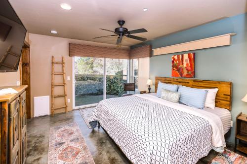 a bedroom with a large bed with a ceiling fan at Cozy Cactus Inn in Sedona