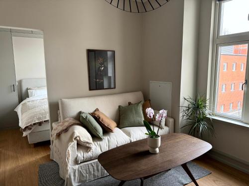 a living room with a couch and a table at The Embassy in Lund