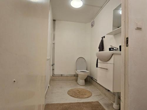 a bathroom with a toilet and a sink at Relax Place in Svalöv