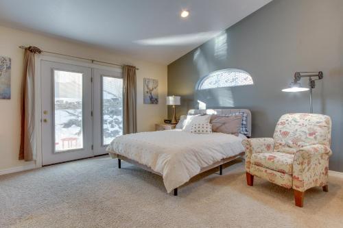 a bedroom with a bed and a chair and a window at Inviting Great Falls Home with Wraparound Deck! in Great Falls