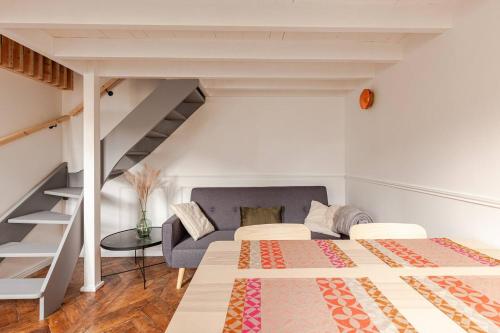 a bedroom with two beds and a staircase at L'Ermitage in Rambouillet