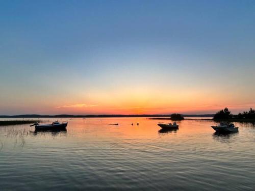 a group of boats on the water at sunset at Villa Marina de Talaris, Lacanau in Lacanau