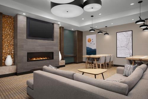 a living room with couches and a fireplace at Holiday Inn & Suites Durango Downtown, an IHG Hotel in Durango