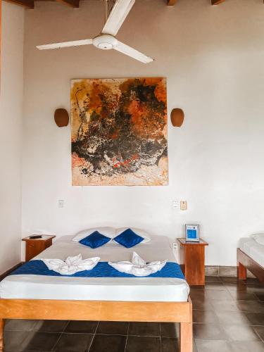 a bedroom with a bed and a painting on the wall at Hotel il Padrino in Granada