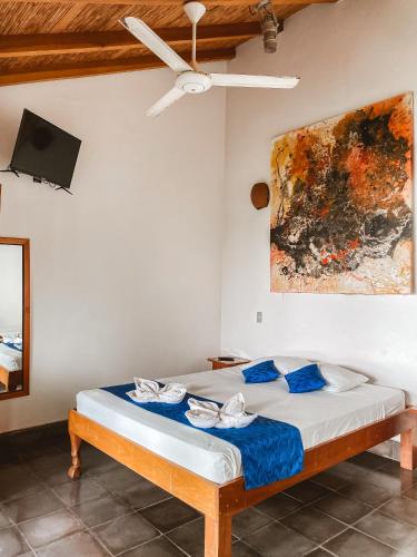 a bedroom with a bed with a ceiling fan at Hotel il Padrino in Granada