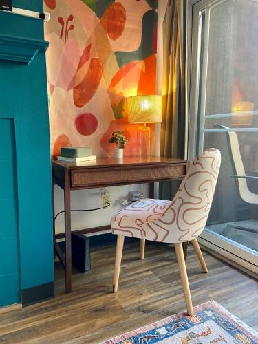 a desk with a chair in front of a table at Quest Travels in Seattle