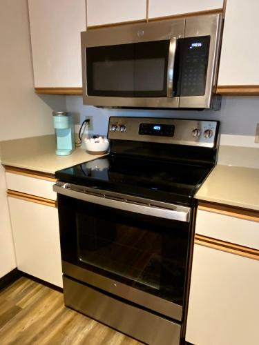 a microwave above a stove in a kitchen at Quest Travels in Seattle