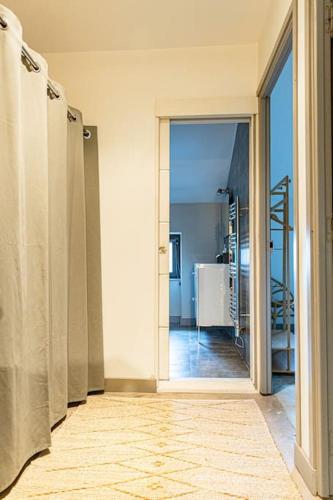 a hallway with an open door to a bathroom at Maison de village Barbentane avec spa in Barbentane
