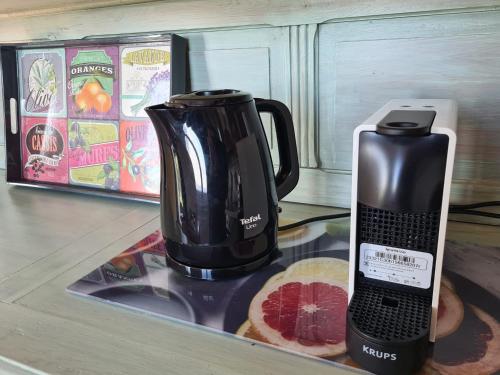 affeepot and a blender sitting on a counter next to a piece at Casa Ulivi e Mare in Ventimiglia