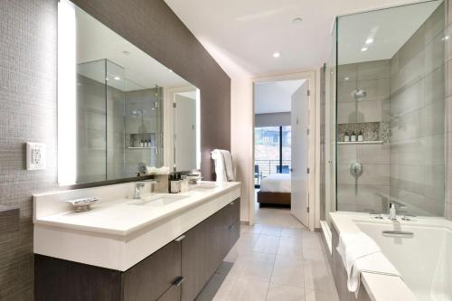 a bathroom with two sinks and a large mirror at Lift Park City Condominiums in Park City