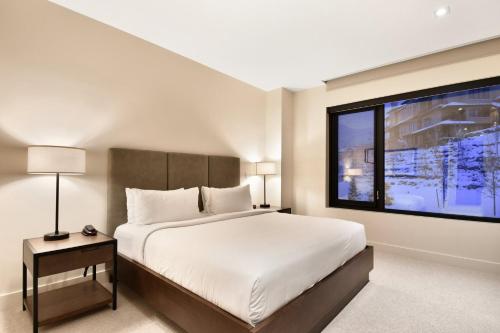 a bedroom with a large bed and a large window at Lift Park City Condominiums in Park City