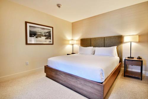 a bedroom with a large bed and two lamps at Lift Park City Condominiums in Park City