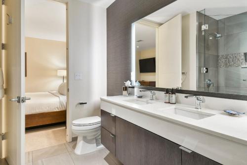 a bathroom with a sink and a toilet and a mirror at Lift Park City Condominiums in Park City