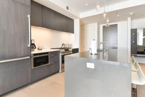 a kitchen with stainless steel appliances and wood cabinets at Lift Park City Condominiums in Park City