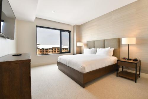a hotel room with a bed and a window at Lift Park City Condominiums in Park City