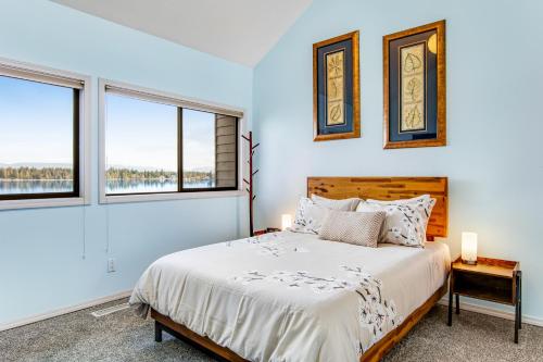 a bedroom with a bed and two windows at Zen Oasis On Lake Tapps in Sumner