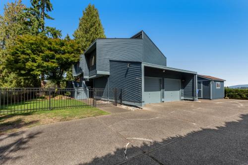 a gray house with a fence in a parking lot at Zen Oasis On Lake Tapps in Sumner