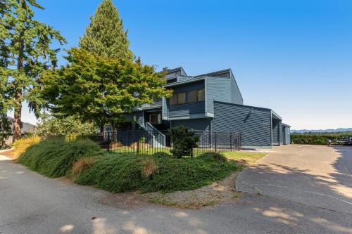 a gray house with a tree in front of it at Zen Oasis On Lake Tapps in Sumner