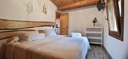 a bedroom with a large bed in a room at Quinta de Sito in Chantada