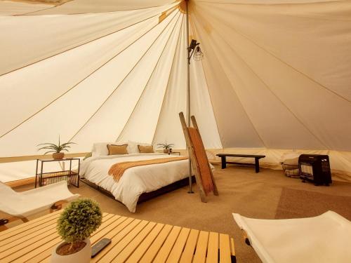 a bedroom with a bed in a tent at Gateway Glamping in Gateway