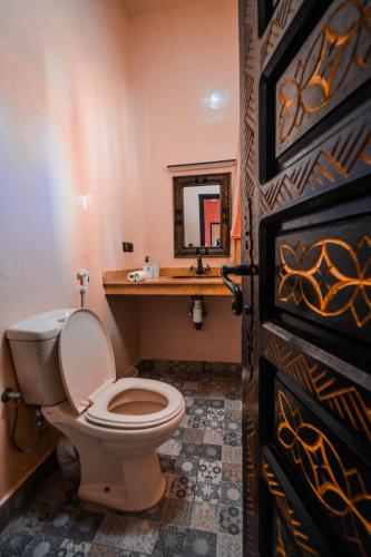 a bathroom with a toilet and a sink at Villa jamal essaouira in Essaouira