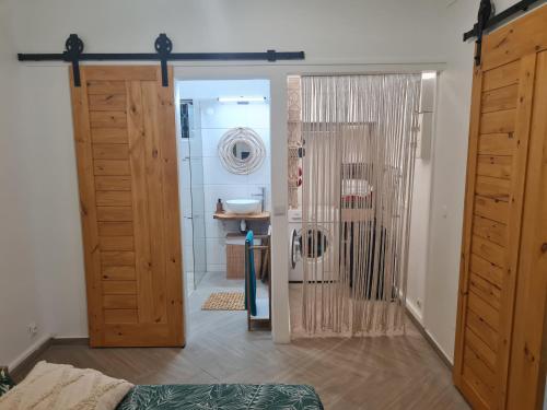 Zimmer mit Bad mit Dusche und Tür in der Unterkunft Gîte L'instant Cocooning in Baie-Mahault