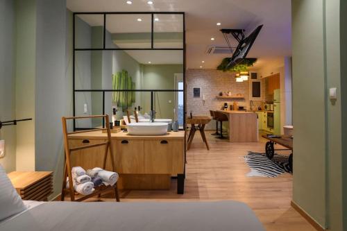 a bedroom with a bathroom with a sink and a kitchen at Hidden Garden of Kallithea in Athens