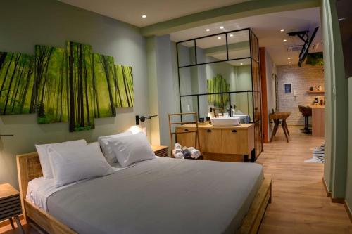 a bedroom with a large bed and a bathroom at Hidden Garden of Kallithea in Athens