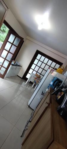 a kitchen with two windows and a counter top at Hostel de Gaia in Santa Cruz do Sul