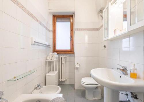 ein weißes Bad mit einem WC und einem Waschbecken in der Unterkunft Appartamento76 in Florenz