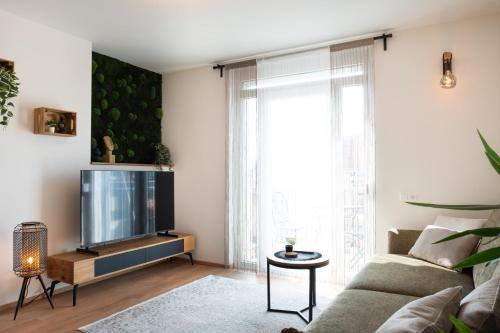 a living room with a couch and a tv at MH Living - 22 - Scandinavian Living Dream in Center in Graz