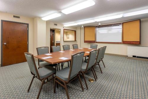 a conference room with a wooden table and chairs at Pear Tree Inn St. Louis Near Union Station in Saint Louis
