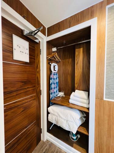 a room with a closet with wooden walls at Cheshire Hotel Central London in London