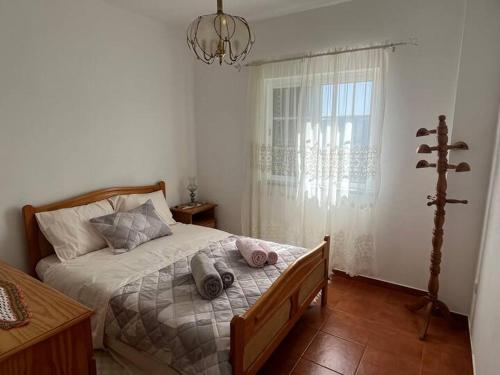 a bedroom with a bed with two stuffed animals on it at Ecorustics stay - Casa Ester in Ester