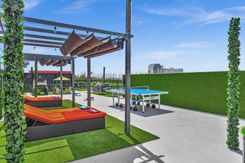 a rendering of a playground with a table and benches at Ocean Wave Deluxe Brand New Apartments in Fort Lauderdale