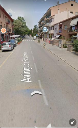 an empty street with white markings on the road at ESTUDIO COMPLETO FAMILIAR in La Jonquera