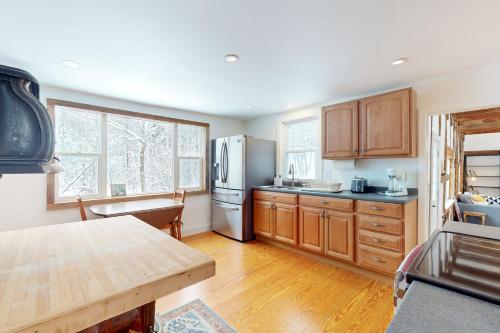 a kitchen with wooden cabinets and a refrigerator at Starry Plough in Bridgewater