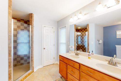 a bathroom with two sinks and a shower at Pleasants View in Bumpass
